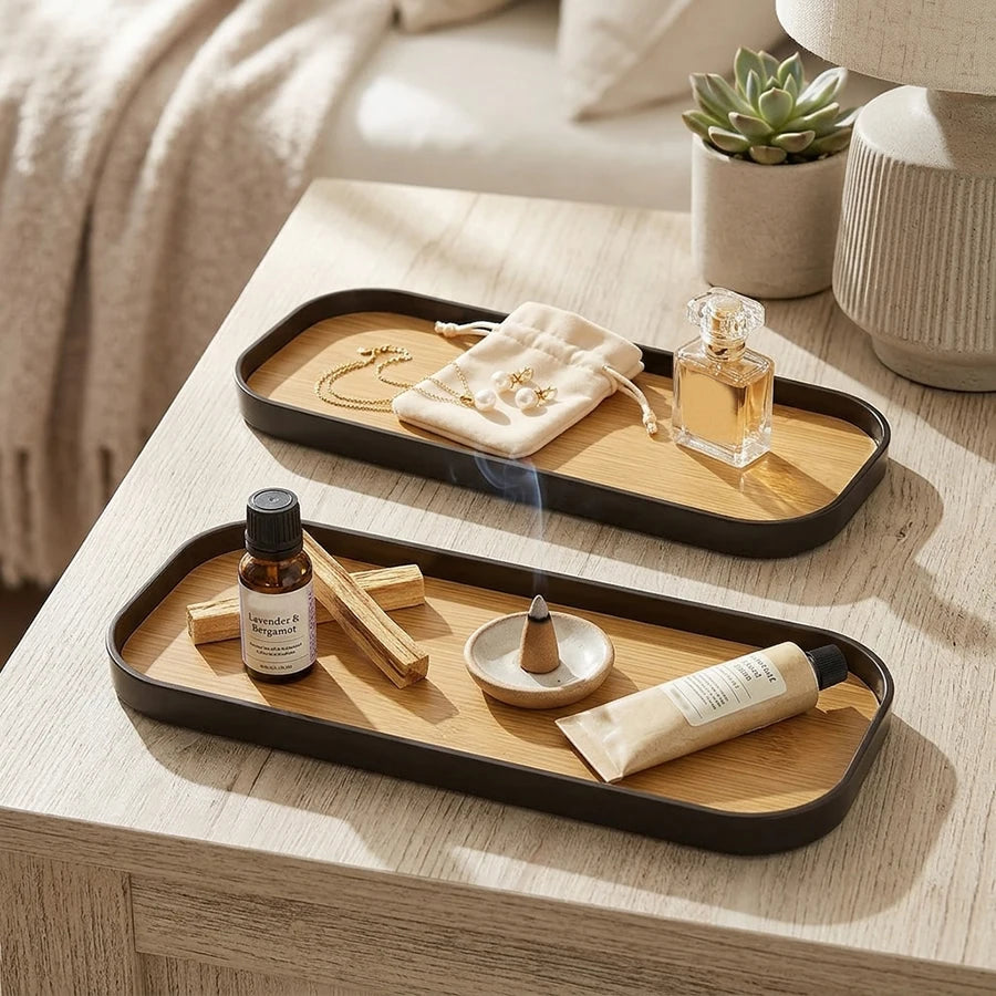 Black rim vanity trays on a nightstand organizing jewelry, perfume, and aromatherapy items