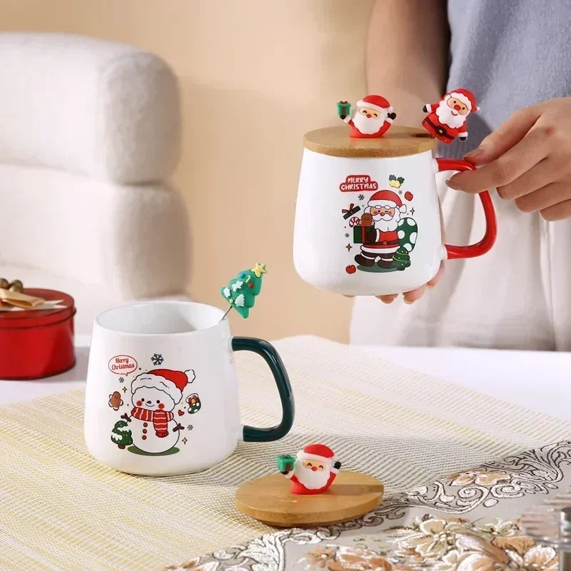 Two ceramic holiday mugs, each with a Christmas-themed lid and spoon, in a bright kitchen scene