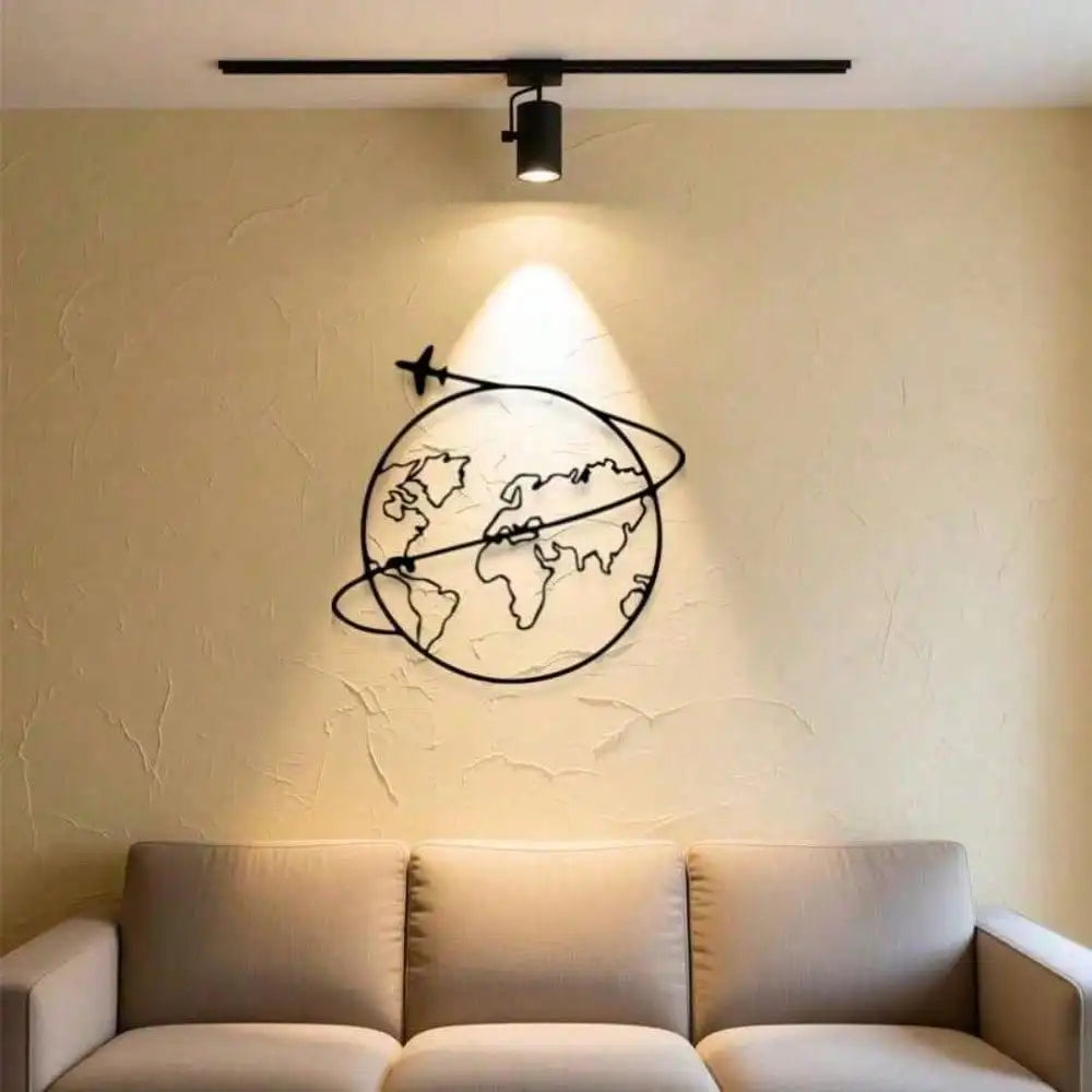 Metal world map wall decor with airplane accent above a beige sofa in modern living room