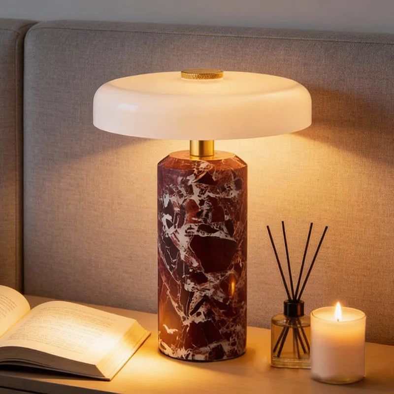 Marble base bedside table lamp on nightstand with cozy candlelight