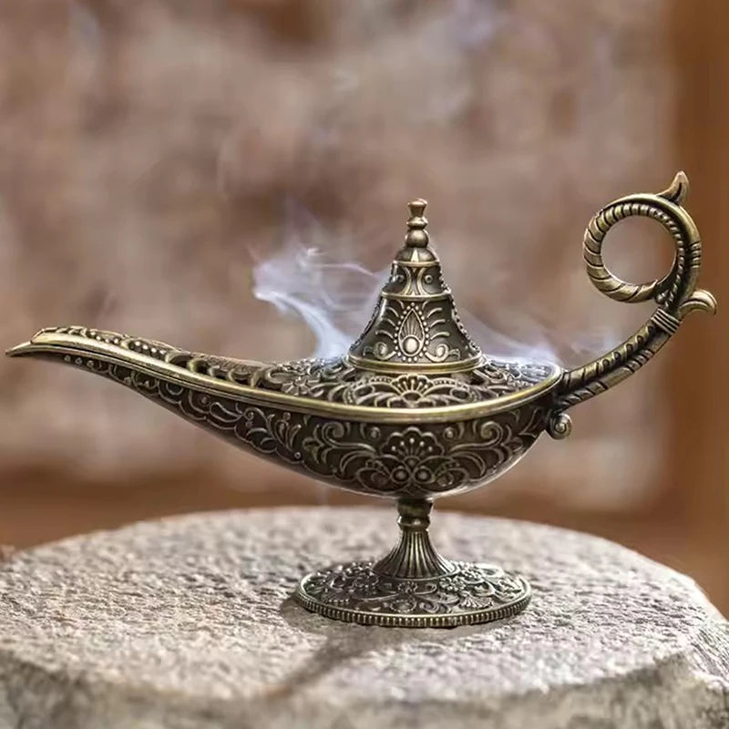ornate metal incense burner lamp with floral relief, smoke wafting from spout