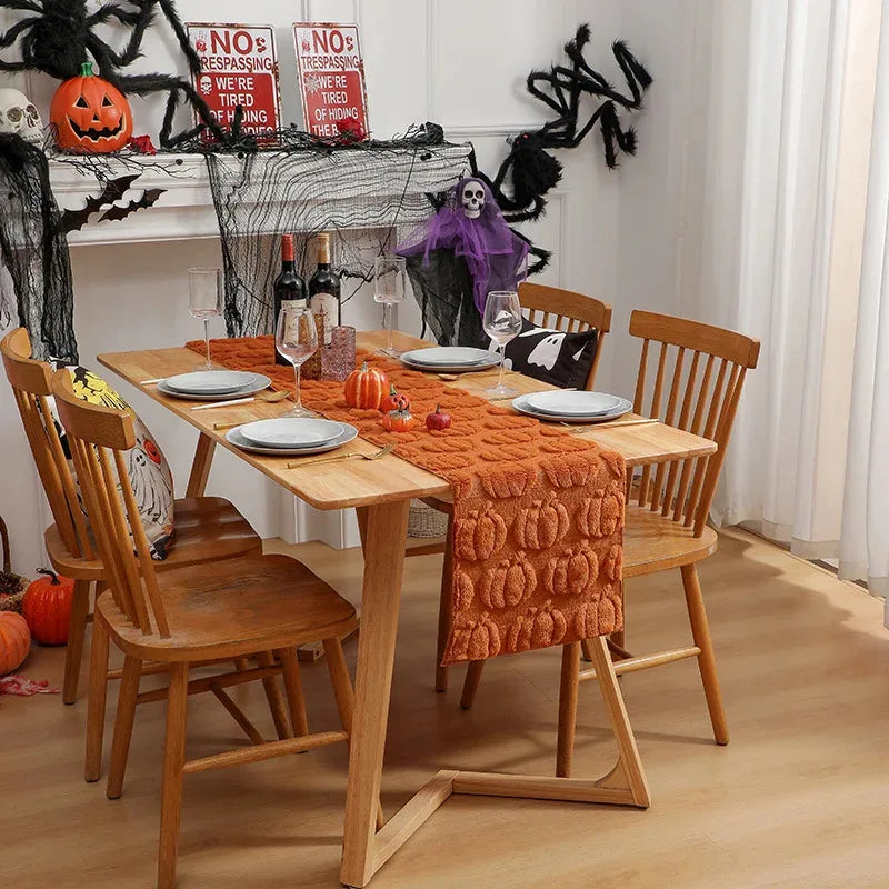 full dining scene with pumpkin table runner and Halloween themed accents