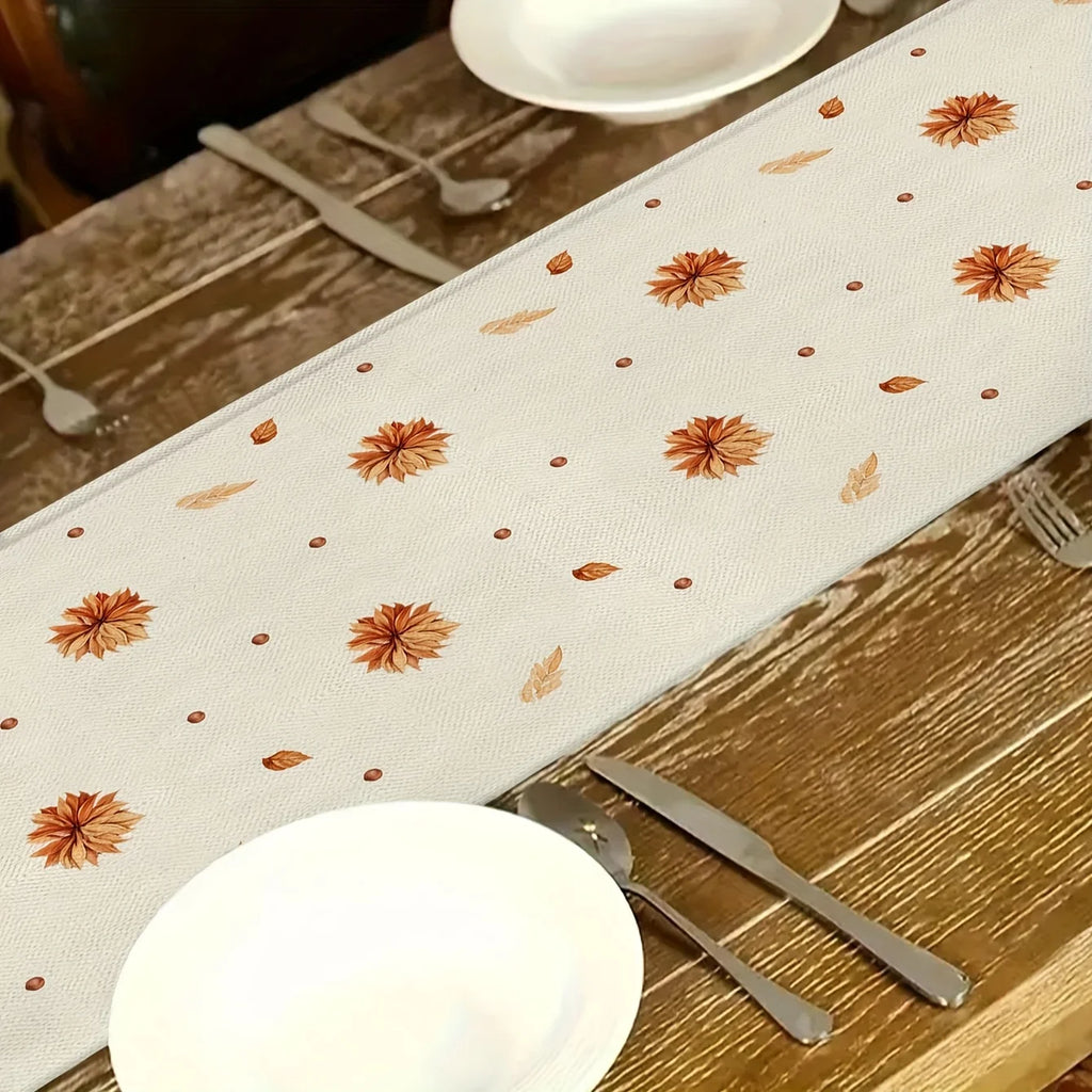 fall floral patterned table runner with orange leaves on dining setup