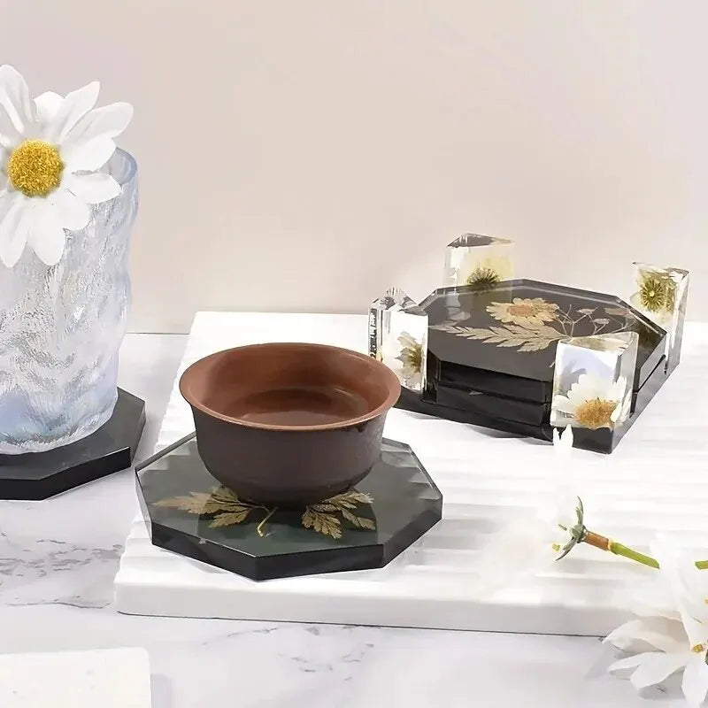 Resin coasters with floral designs in use with cups and glasses on a home surface.