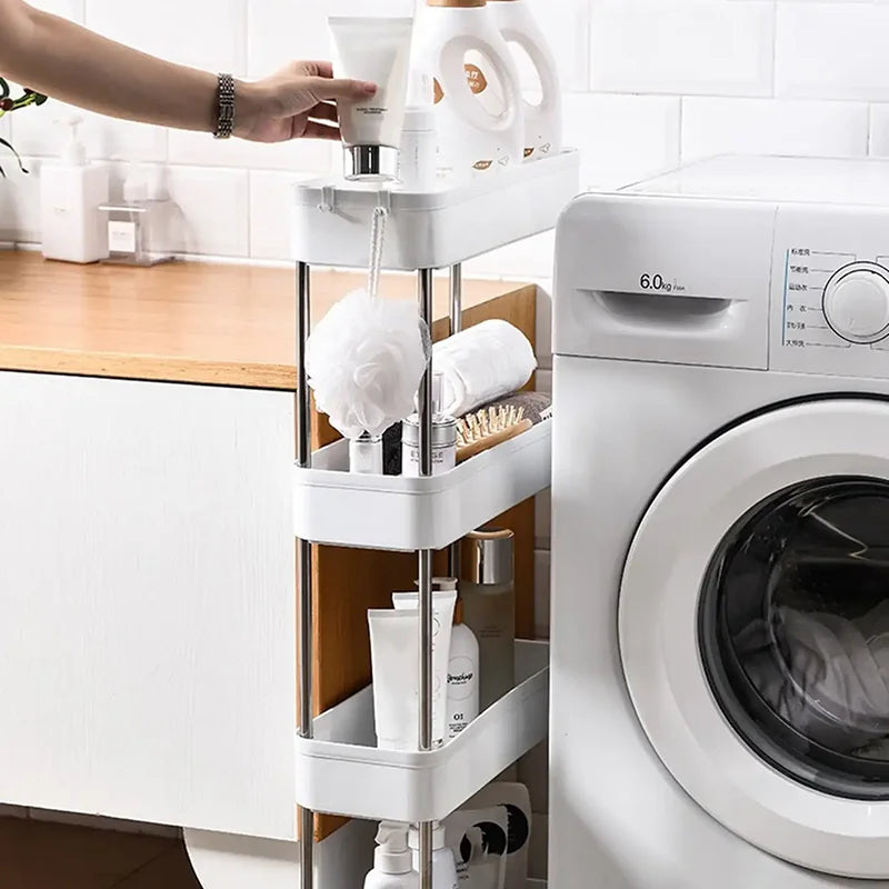 Slim white rolling cart placed beside a washing machine, stocked with bathroom and laundry supplies