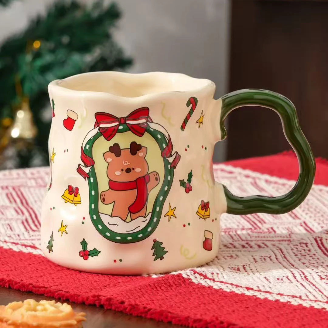 Reindeer ceramic Christmas mug with green handle displayed on festive table