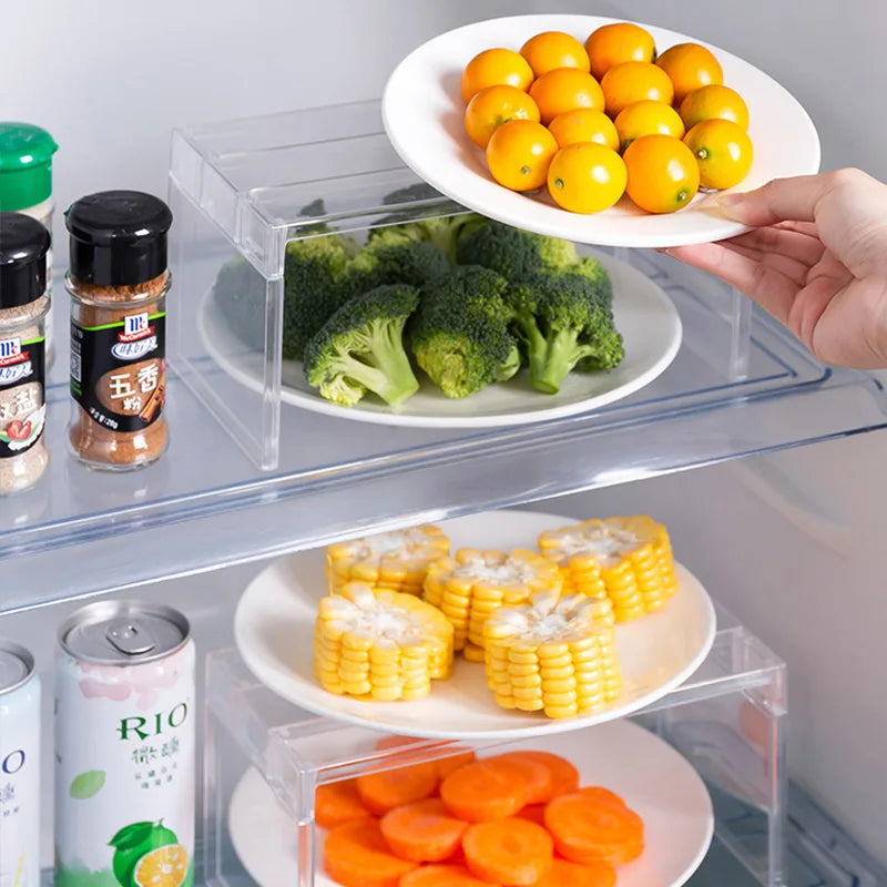 Hand placing clear plastic shelf organizer on a fridge shelf