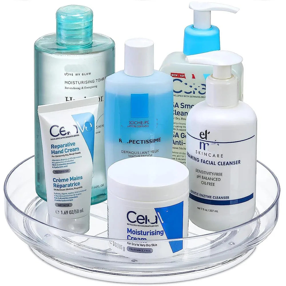 clear lazy susan holding several bottles of skincare and personal care products