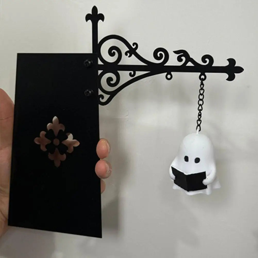 Hand holding iron bookshelf lamp with ghost lantern for size and detail view