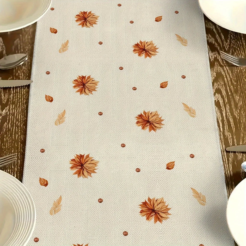 detail view of autumn leaves printed on a table runner set for dinner