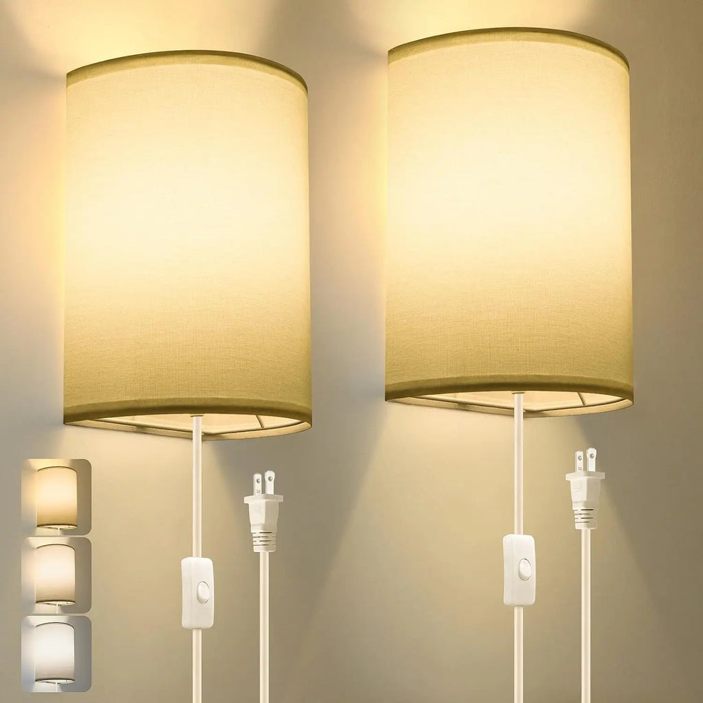 Pair of beige plug-in wall sconce lamps with fabric shades, showing warm LED lighting in a neutral room