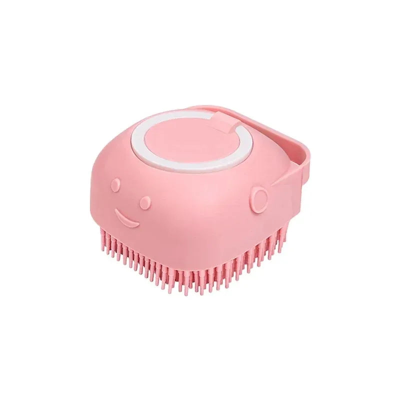 Pink dog bath brush with a built-in refillable shampoo dispenser and rubber bristles, on a white background