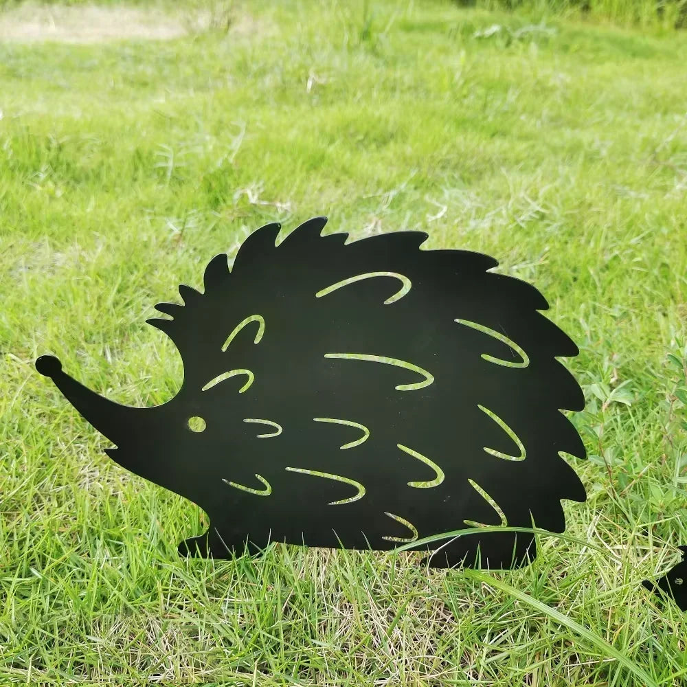 Large black metal hedgehog stake closeup on lawn