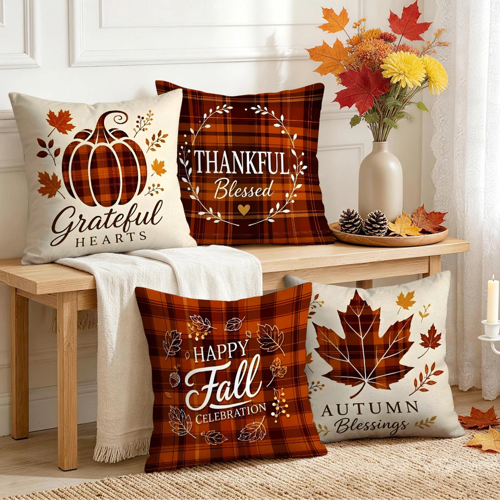 Set of four autumn-themed plaid throw pillow covers on a bench, featuring pumpkin and maple leaf designs with fall sayings.