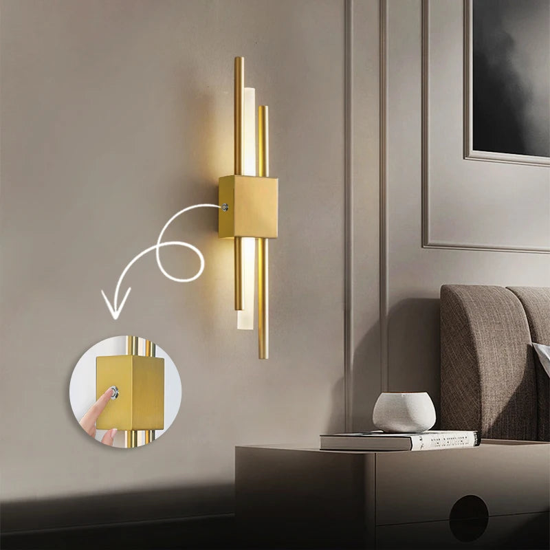 Gold LED wall sconce lamp with touch switch mounted beside bed