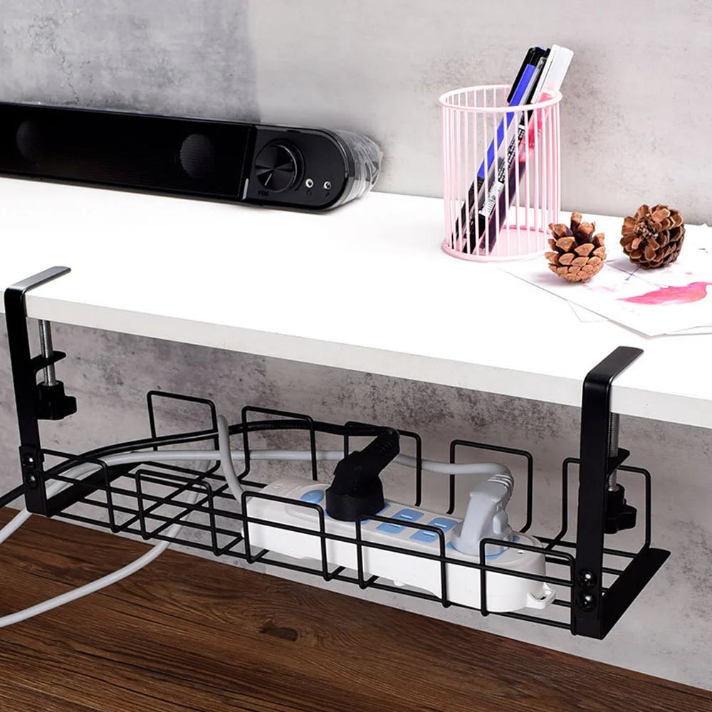 Cable organizer tray installed under a white desk managing cords and power strip