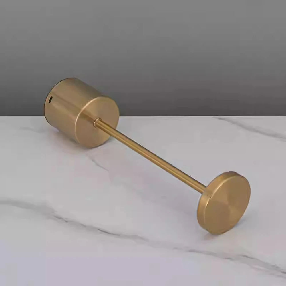 Gold touch lamp lying flat on a marble surface