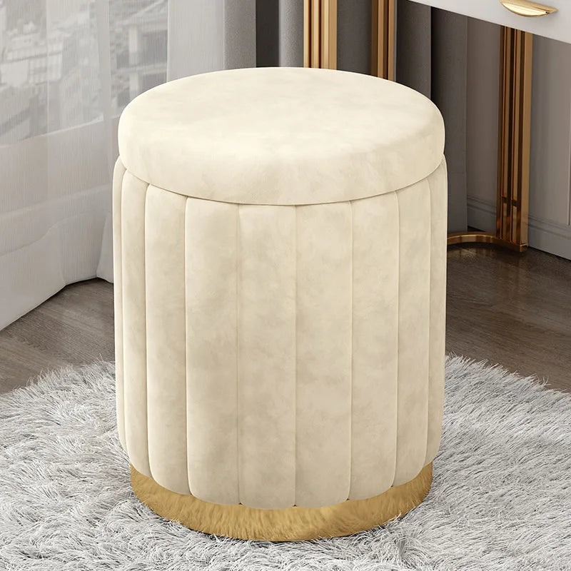Round cream storage stool ottoman on a shaggy rug beside a vanity table