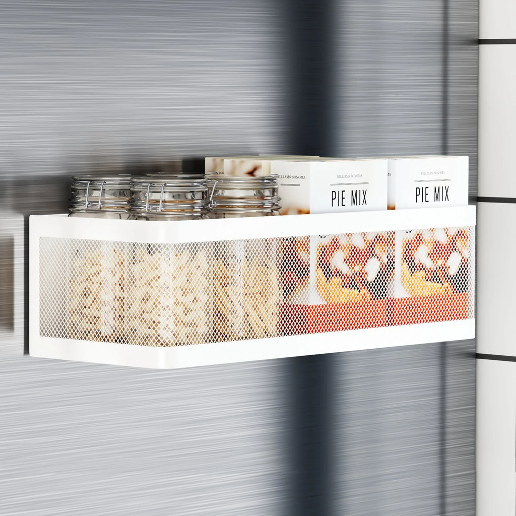 White magnetic storage basket on a fridge, holding glass jars and boxes of pie mix.