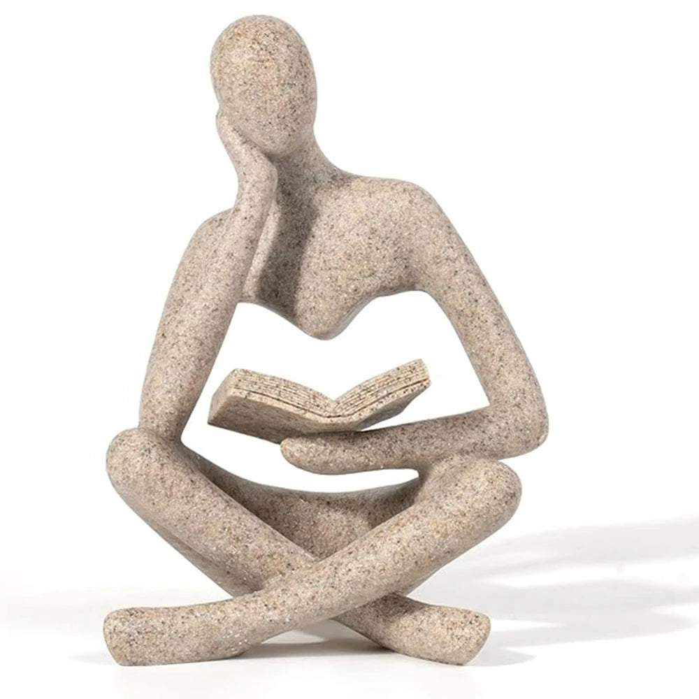 Beige abstract reader resin sculpture with book, shown on white background