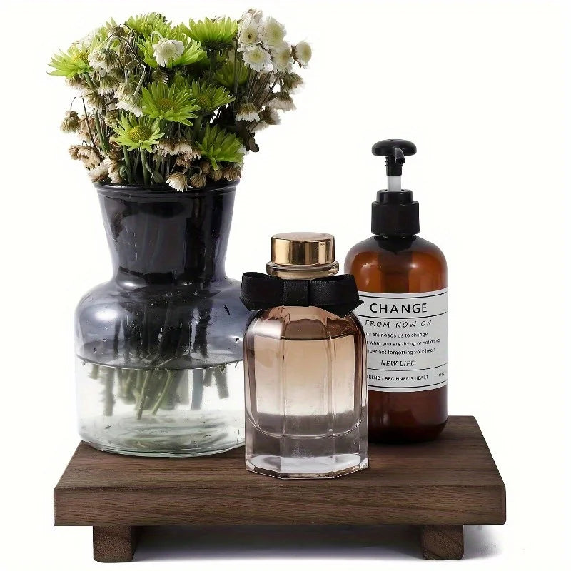 Solid wood pedestal tray holding vases and bottles, suitable for bathroom or vanity organization