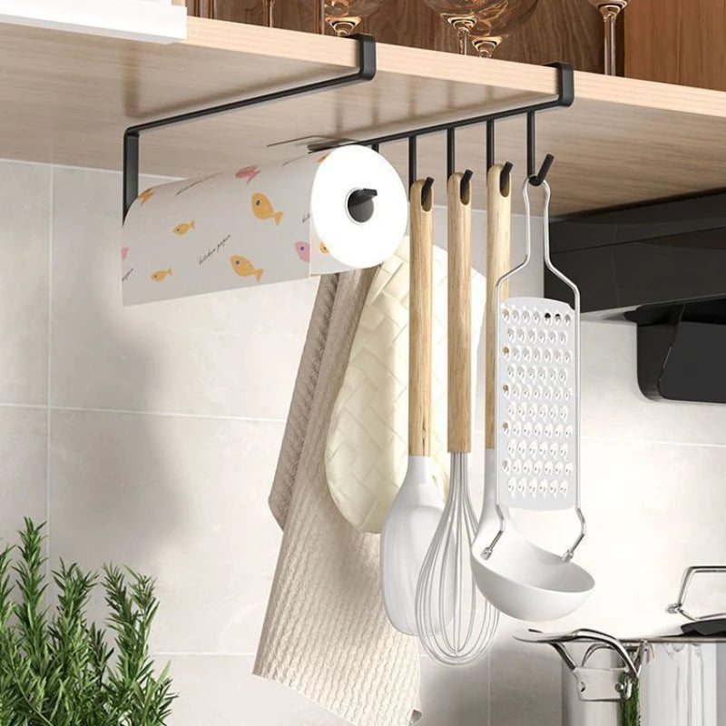 black under-cabinet hook rack holding paper towels and kitchen utensils under a wooden shelf