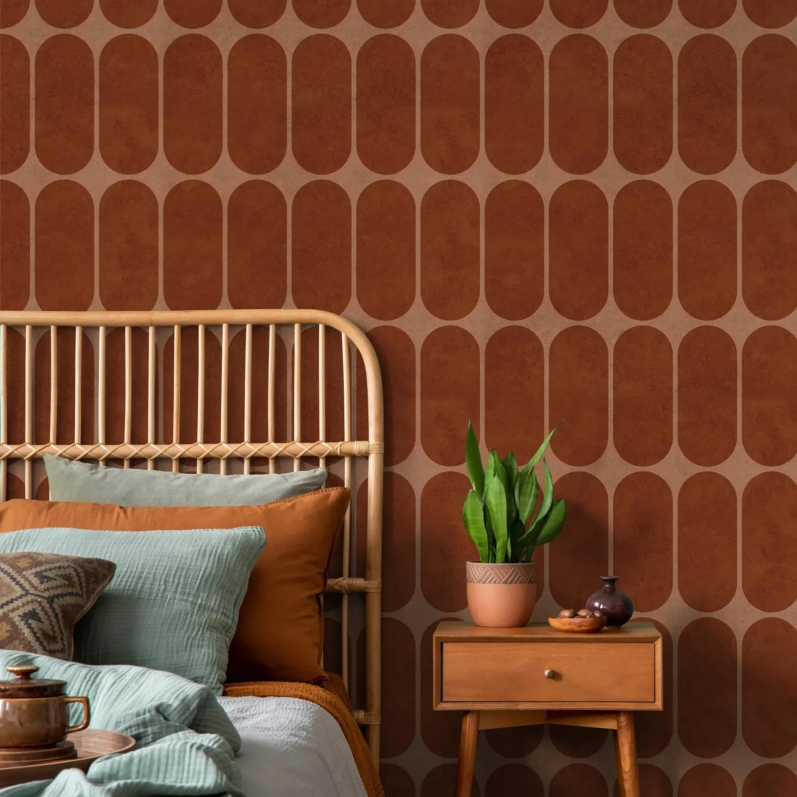 Terracotta arch geometric wallpaper as a statement wall behind rattan bed in bedroom