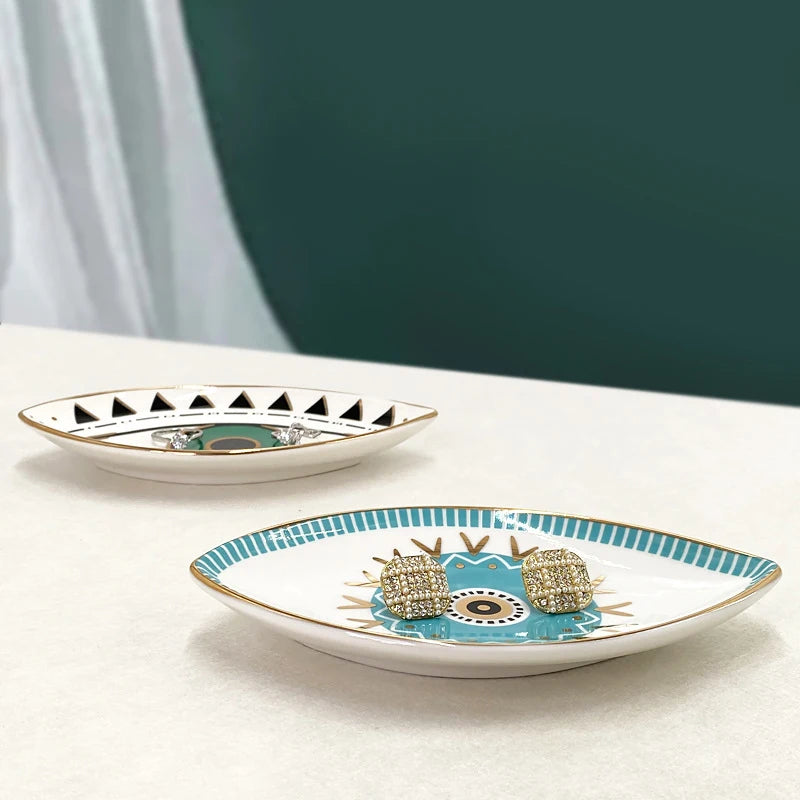 Side view of turquoise and black eye design jewelry trays holding earrings