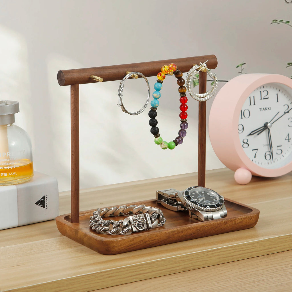 Jewelry organizer stand holding colorful bracelets and watch on a bedside or dresser surface