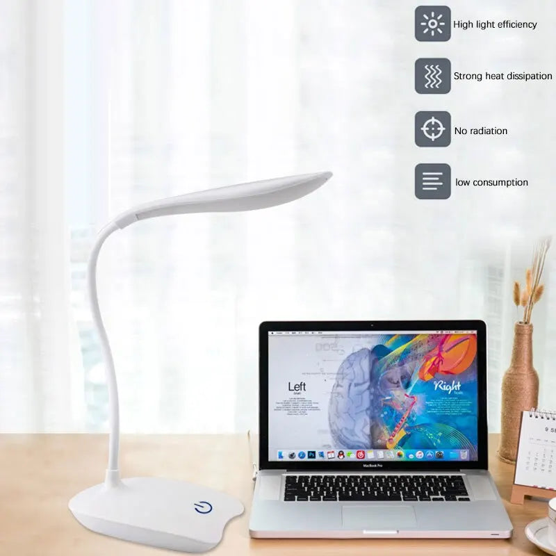 White LED desk lamp with flexible neck positioned beside a laptop on a home office desk