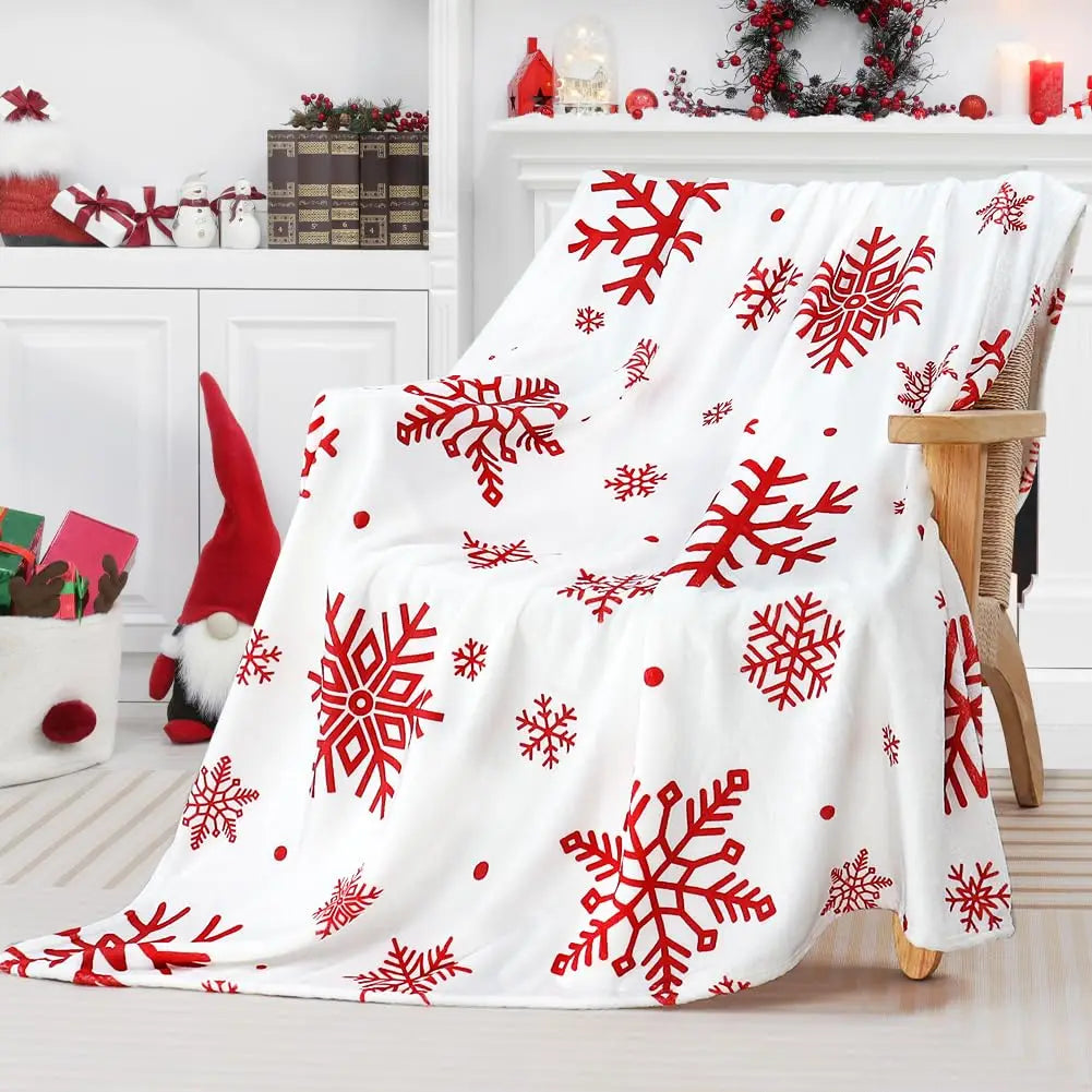 Red snowflake flannel blanket on a wooden armchair in a white decorated room