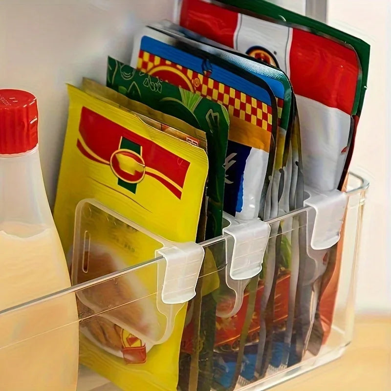 Clear fridge dividers organizing upright food packets in a refrigerator bin