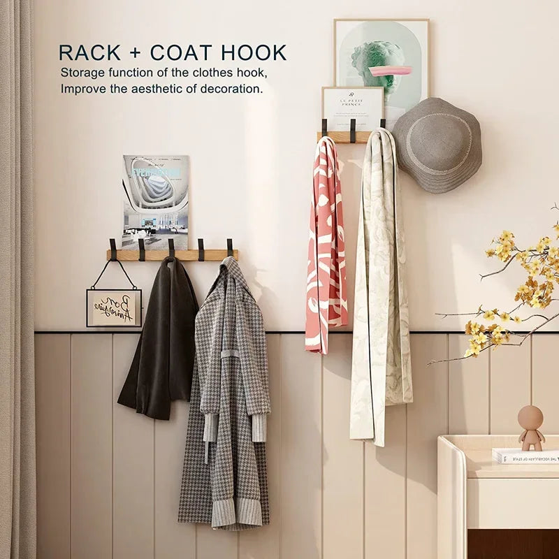 entryway with two oak coat racks, each holding coats, scarves, hats, and decorative art