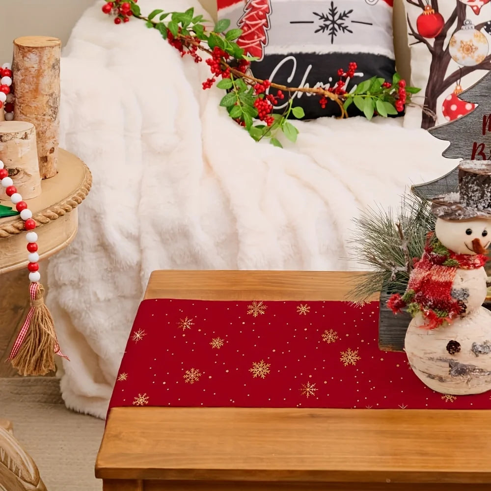 Festive red table runner with gold snowflakes on a coffee table in a cozy living room with holiday decor