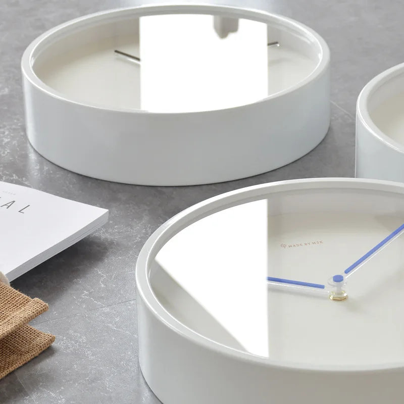 Close view of minimalist wall clocks with reflected glass face