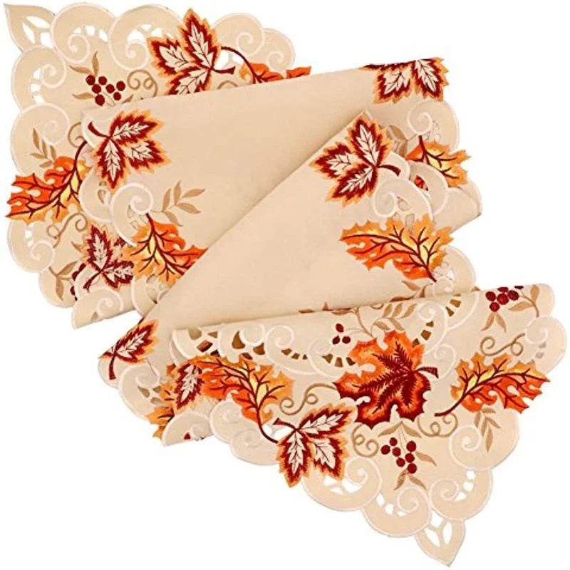 Folded maple leaf embroidered table runner highlighting scalloped edges