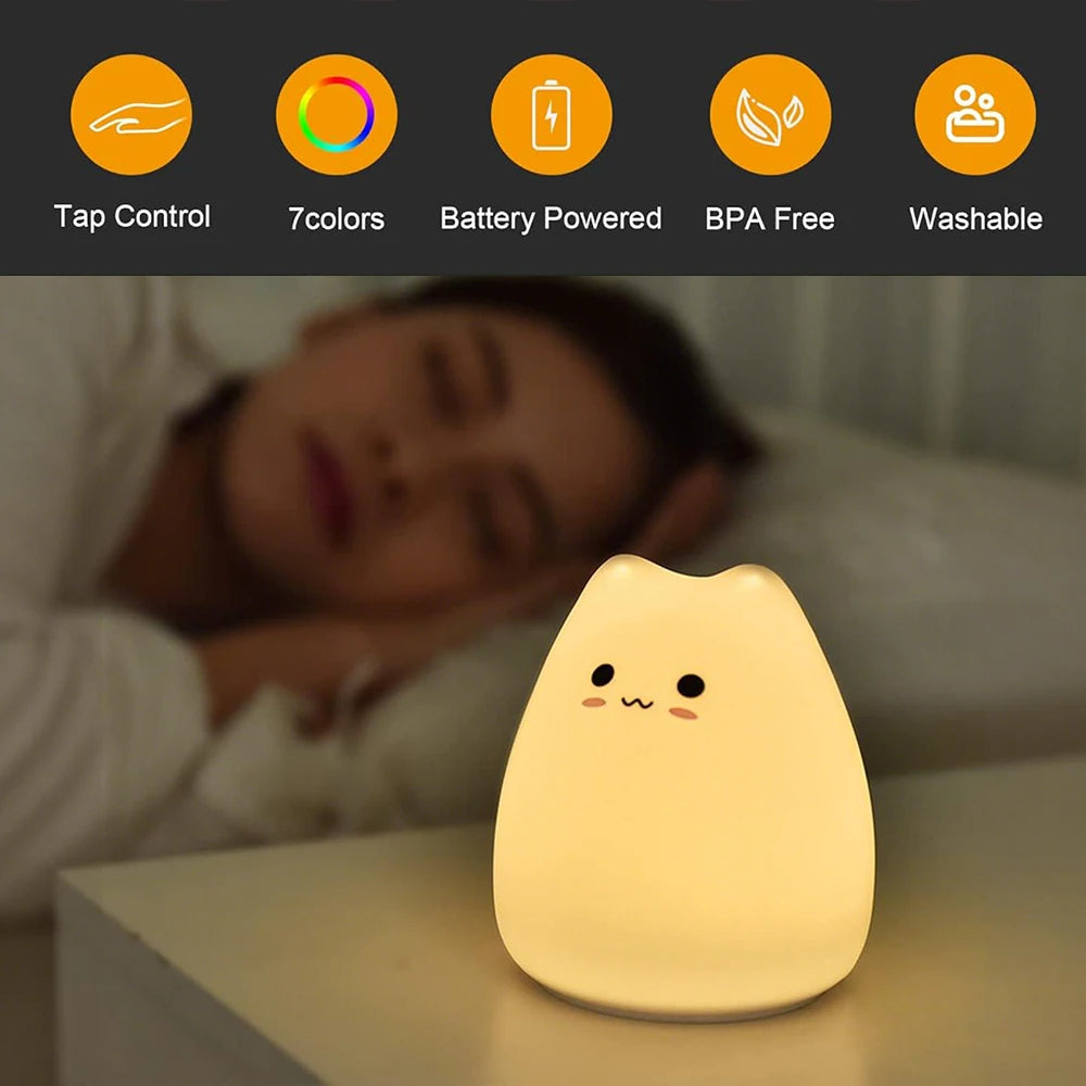 Child sleeping beside a glowing cat night light, with icons for tap control and battery power
