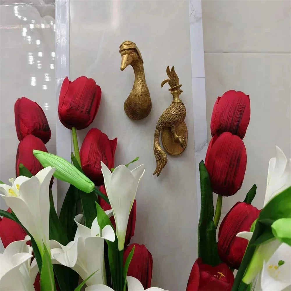 gold animal wall hooks with tulip and lily flower arrangements nearby