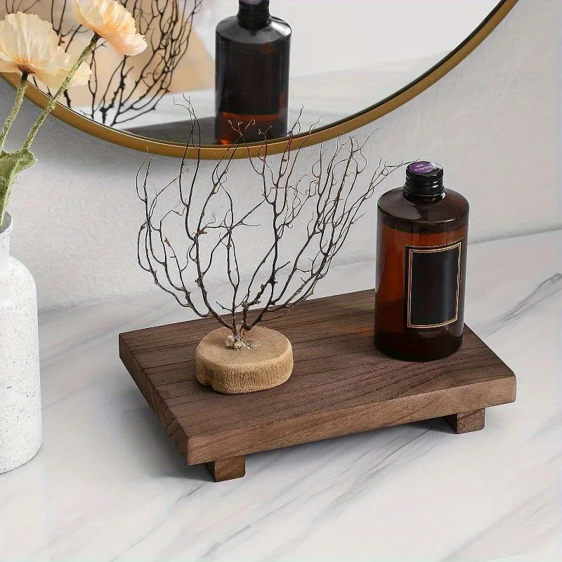 Rectangular wooden riser tray on a marble vanity, decorated with a bottle and small arrangement