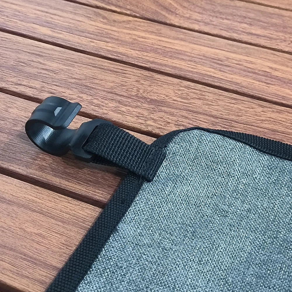 Detail view of the storage bag's clip and attachment strap