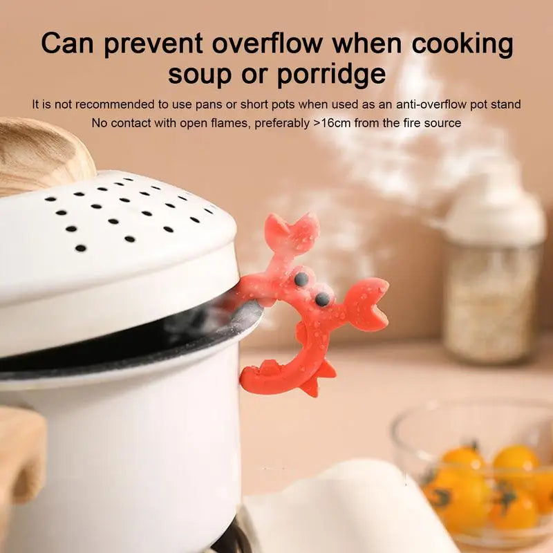 Red crab-shaped silicone utensil rest propping open a pot lid with steam rising in a cozy kitchen setting