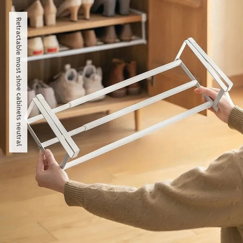 hand holding an expandable white under-shelf shoe rack before installation