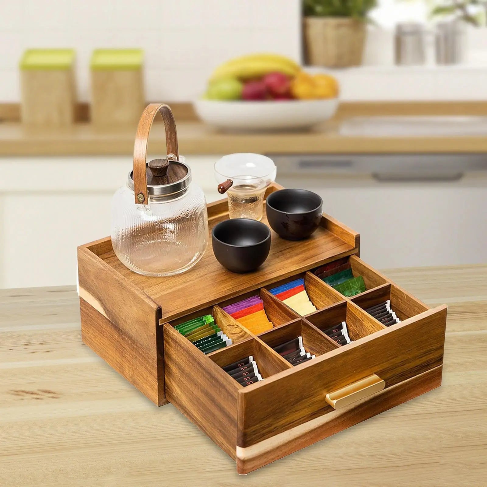 Wood tea bag organizer on kitchen counter with glass and ceramic teacups