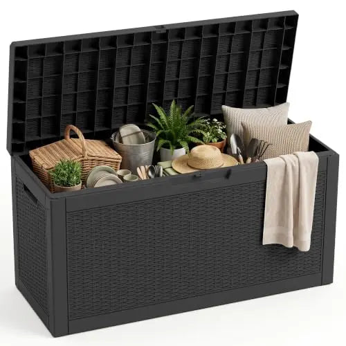 black resin rattan deck storage box shown open with home and garden essentials inside, placed in a neutral setting.
