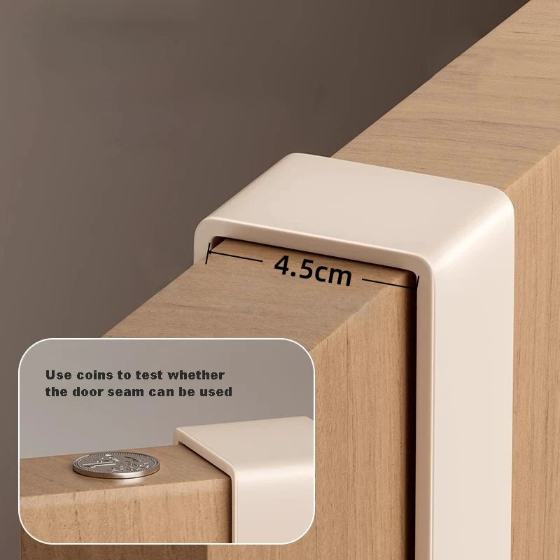 Close-up showing cream rack arm fitting over a door up to 4.5 cm thick with coin for scale