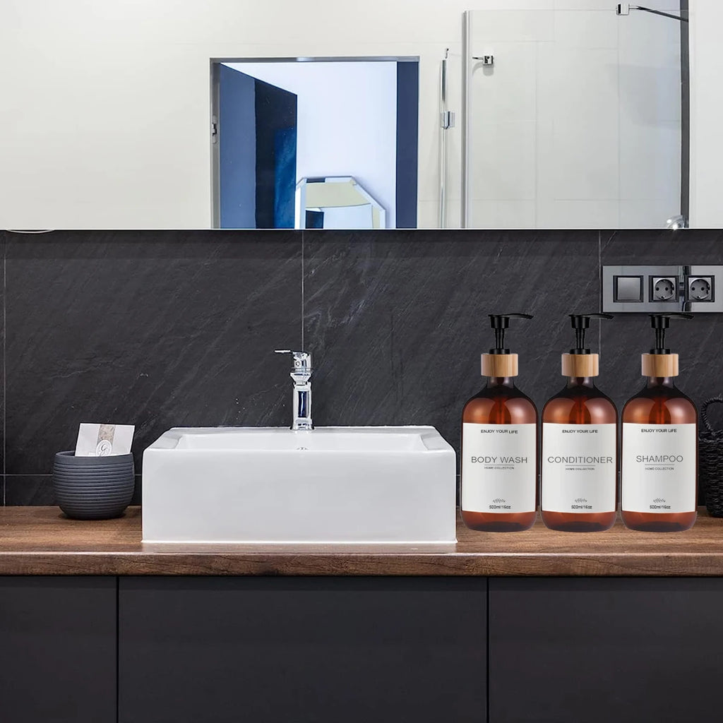 Set of amber plastic pump dispenser bottles arranged on a modern bathroom countertop by the sink