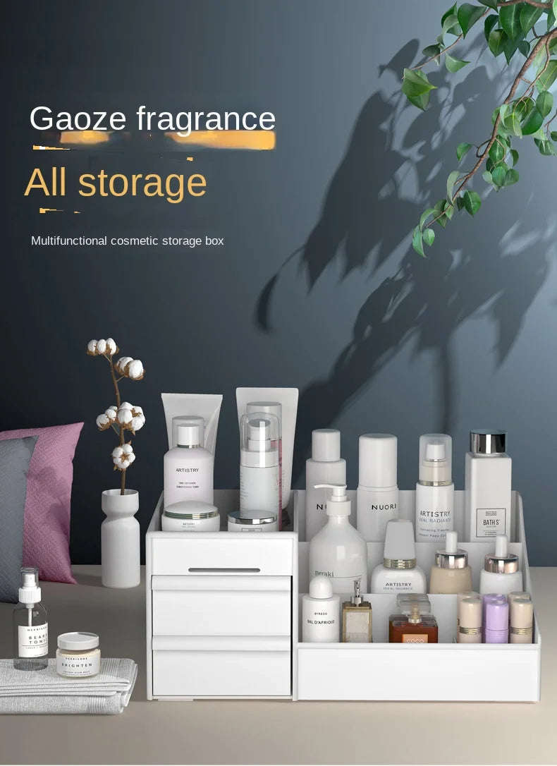 White desktop makeup organizer with drawers holding various bottles and arranged beside decor on a table