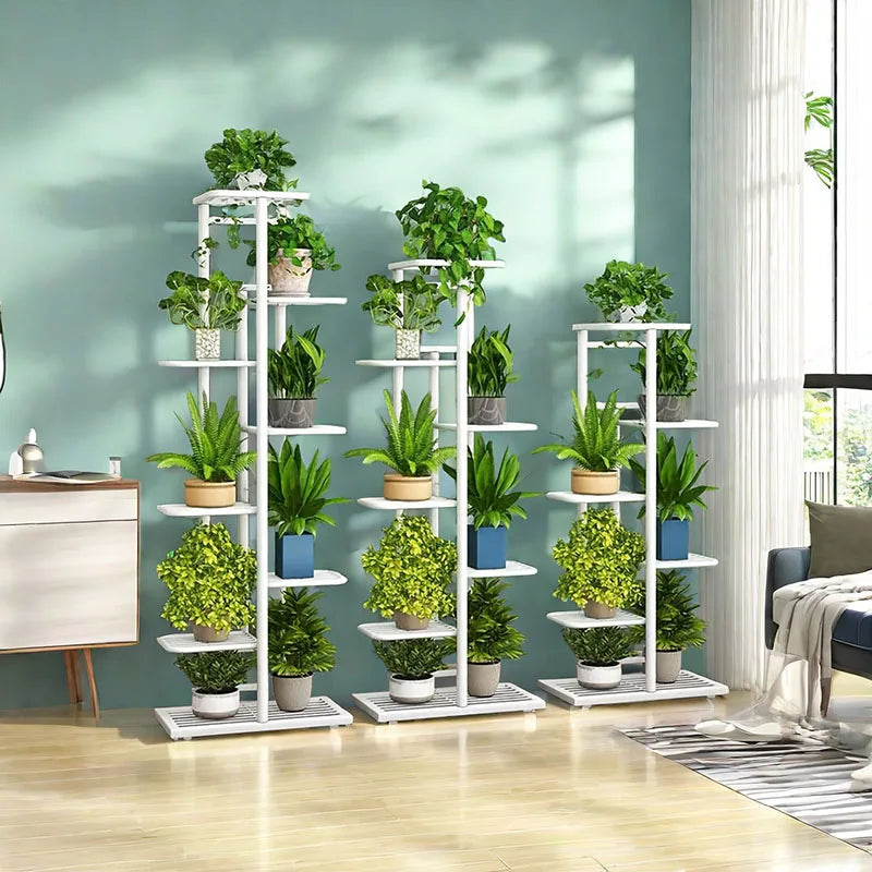 White multi-tier iron plant stands displaying potted plants in a bright living room
