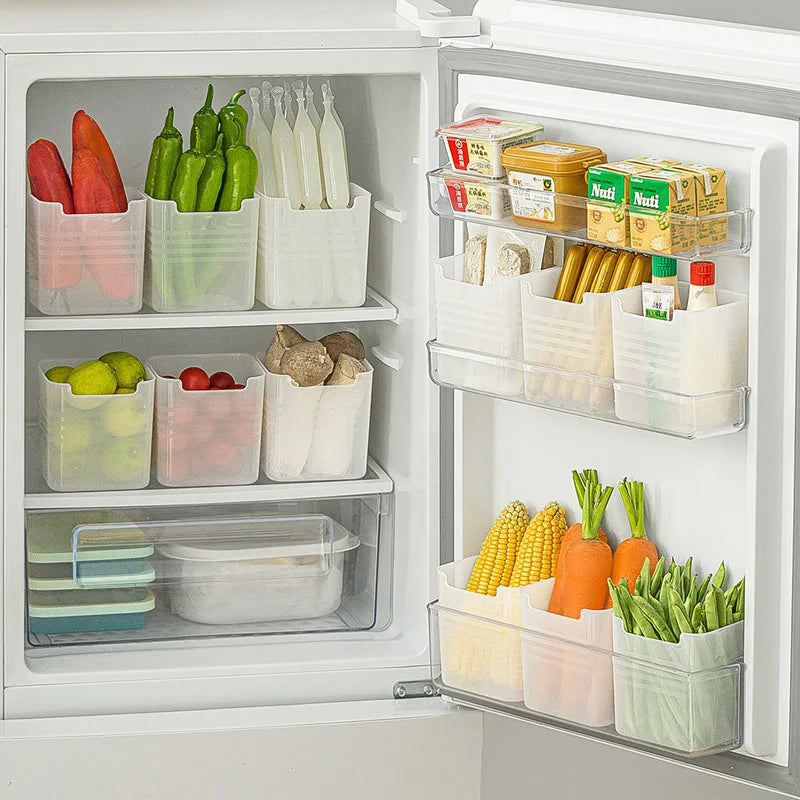 Refrigerator organized with multiple clear plastic bins holding vegetables, fruits, and packaged goods on both shelves and side door compartments