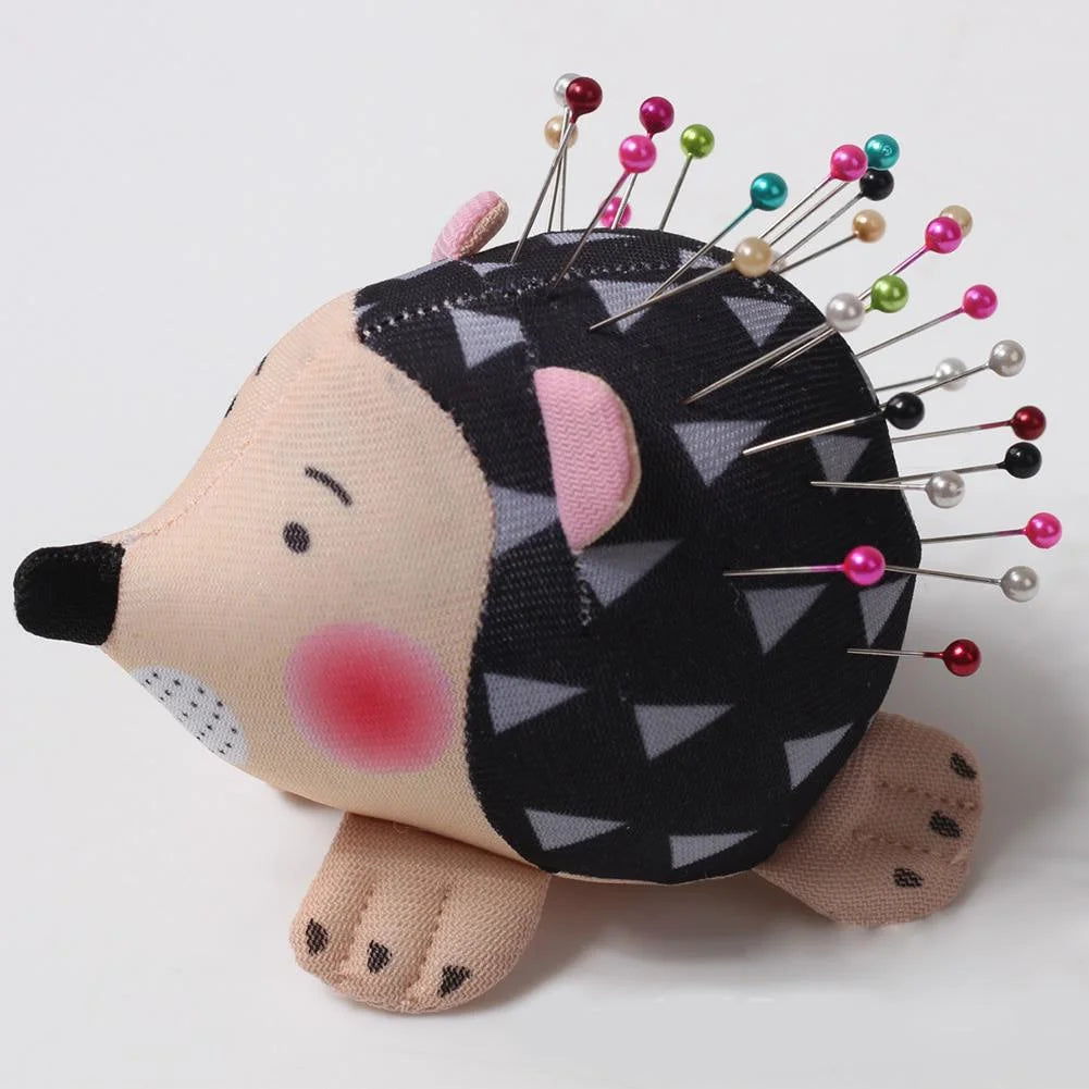 Cartoon hedgehog-shaped pin cushion holding colorful sewing pins